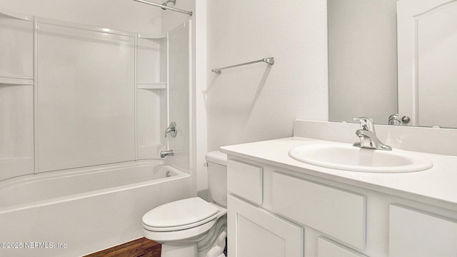 full bathroom featuring hardwood / wood-style flooring, washtub / shower combination, vanity, and toilet