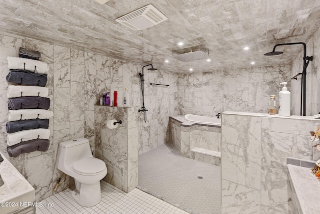 bathroom featuring shower with separate bathtub, toilet, tile floors, and tile walls