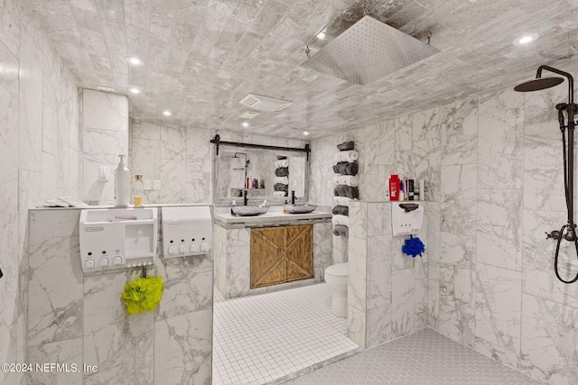 bathroom with tile walls, tiled shower, tile floors, and toilet