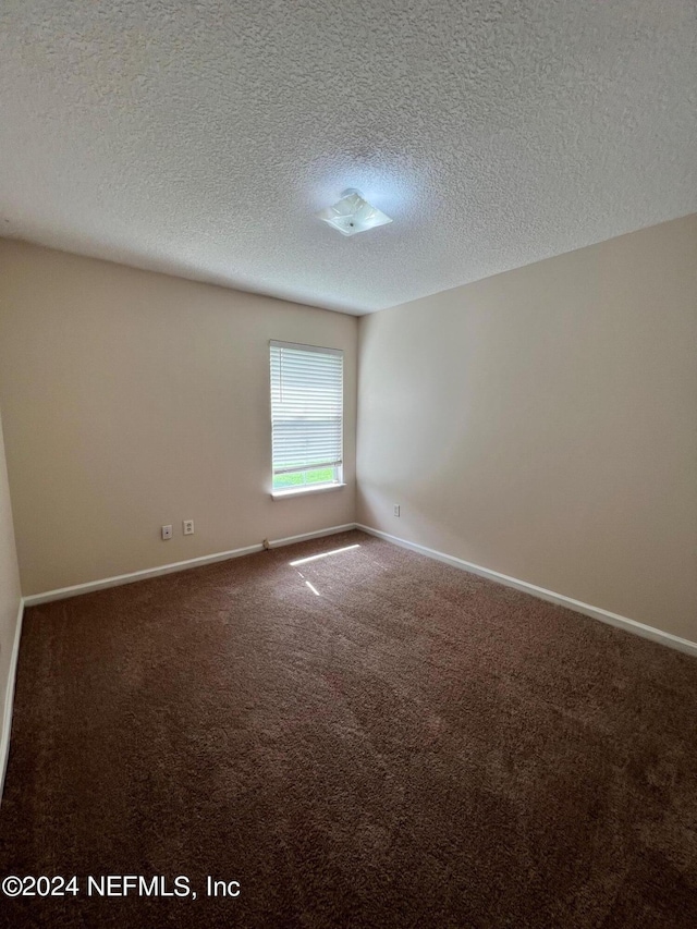 1450 Elsa Dr, Jacksonville, FL 32218 - spare room with carpet floors, baseboards, and a textured ceiling
