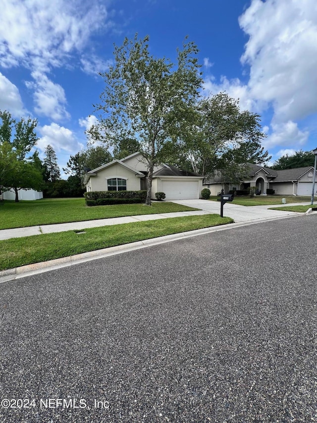 1450 Elsa Dr, Jacksonville, FL 32218 - view of front of property with a front lawn, driveway, and a garage