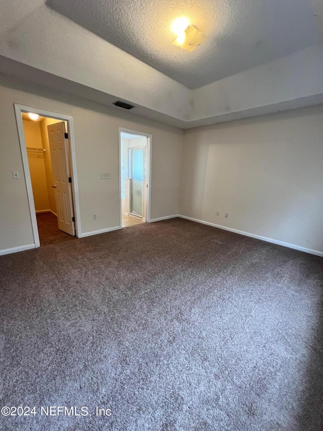 1450 Elsa Dr, Jacksonville, FL 32218 - carpeted empty room with baseboards, visible vents, and a textured ceiling