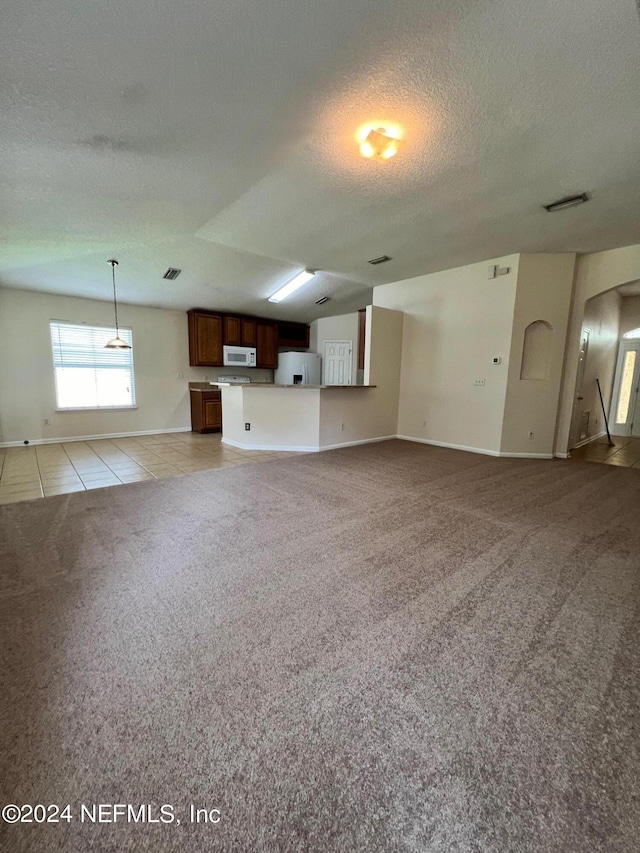 1450 Elsa Dr, Jacksonville, FL 32218 - unfurnished living room featuring light tile patterned flooring, baseboards, light colored carpet, and a textured ceiling
