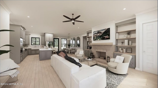 living room with ceiling fan, light wood-type flooring, and ornamental molding