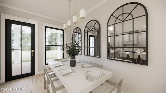 dining room featuring an inviting chandelier, crown molding, and light hardwood / wood-style flooring