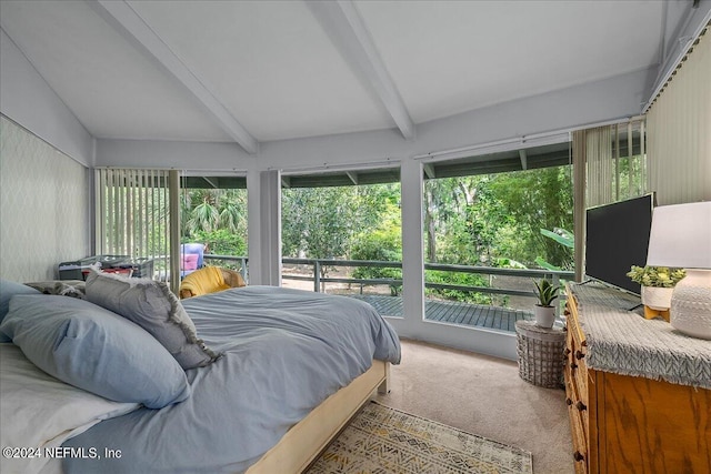 carpeted bedroom with beam ceiling