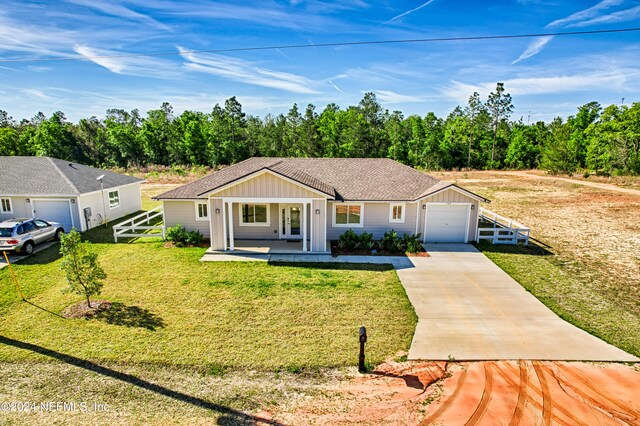 ranch-style house featuring covered porch and a front lawn