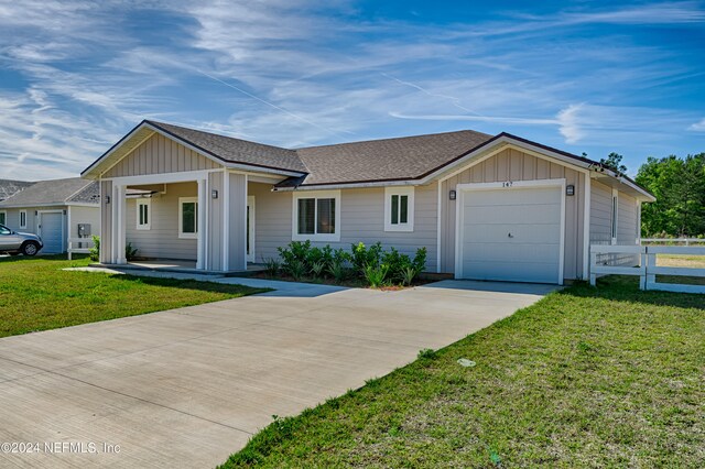 single story home with a garage and a front yard