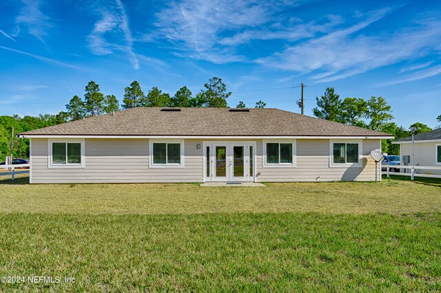 back of property featuring french doors and a yard