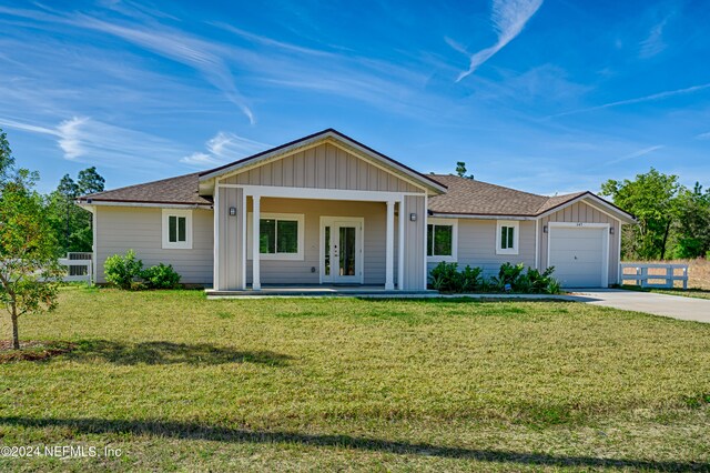 ranch-style house featuring a front lawn and a garage