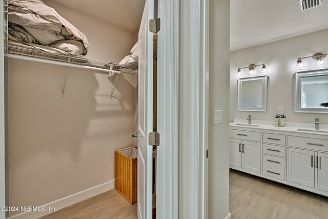 bathroom featuring hardwood / wood-style floors and double sink vanity