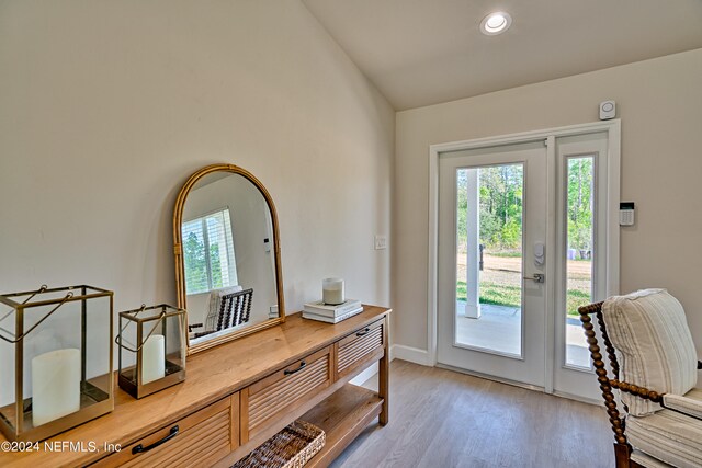 interior space featuring vaulted ceiling and light hardwood / wood-style flooring