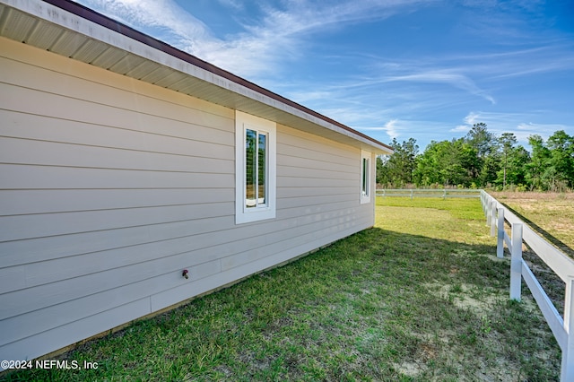 view of side of property with a lawn