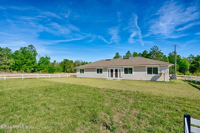 rear view of property featuring a yard