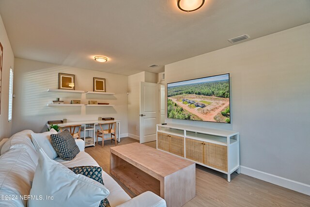 living room with light hardwood / wood-style flooring