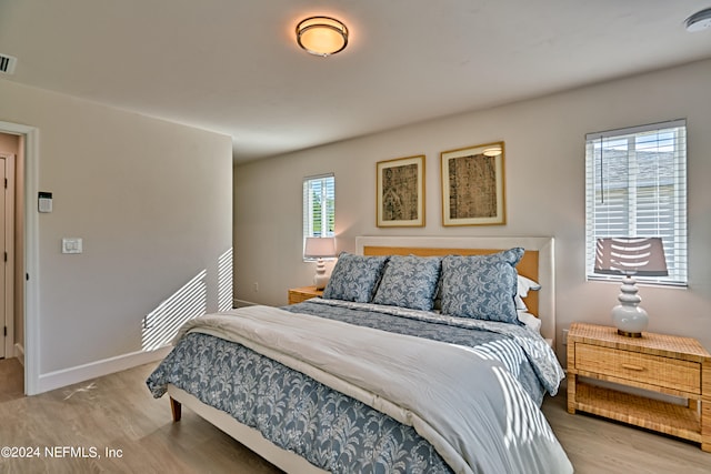 bedroom with light hardwood / wood-style flooring