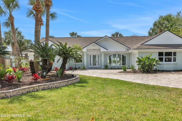 ranch-style home featuring french doors and a front yard