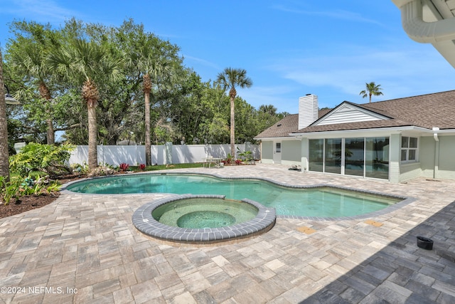 view of swimming pool with a patio and an in ground hot tub