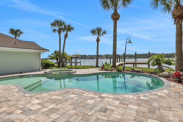 view of pool with a patio and an in ground hot tub