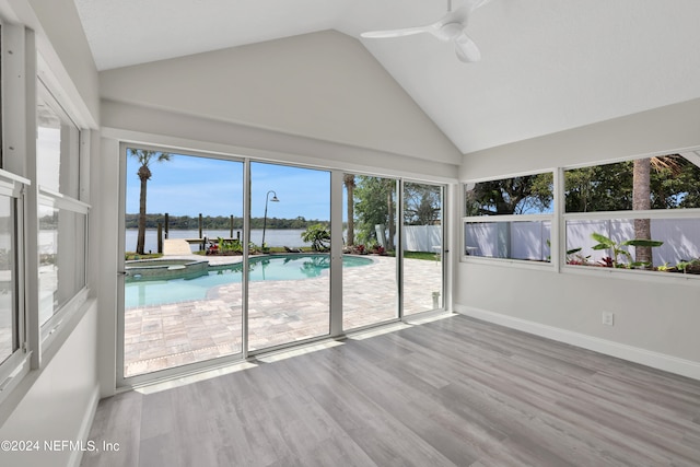 unfurnished sunroom with vaulted ceiling, ceiling fan, and a healthy amount of sunlight