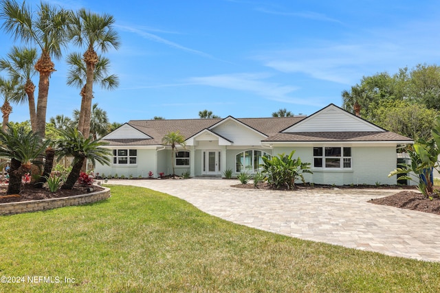 ranch-style home with a front lawn