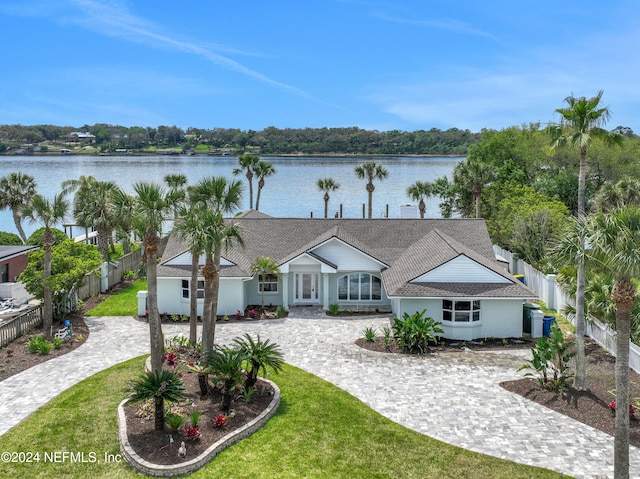 view of front of home featuring a front lawn and a water view