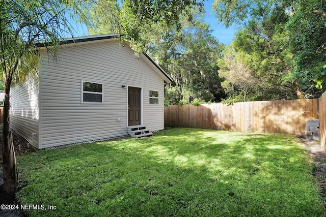 rear view of property with a lawn