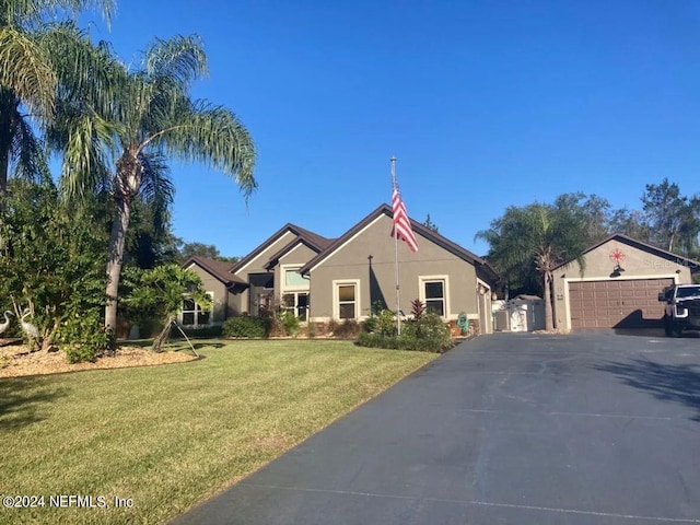 view of front of property featuring a garage and a front lawn