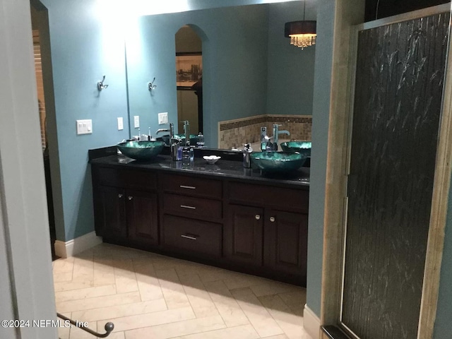 bathroom with dual vanity and tile flooring