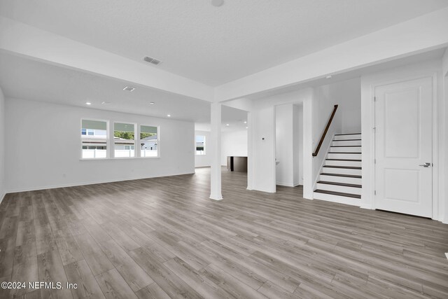 unfurnished living room featuring hardwood / wood-style flooring