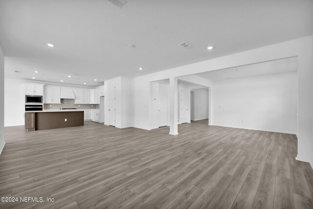 unfurnished living room with hardwood / wood-style flooring