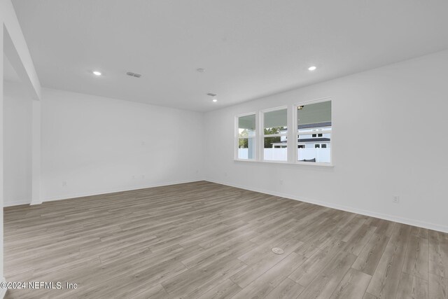 spare room with light wood-type flooring