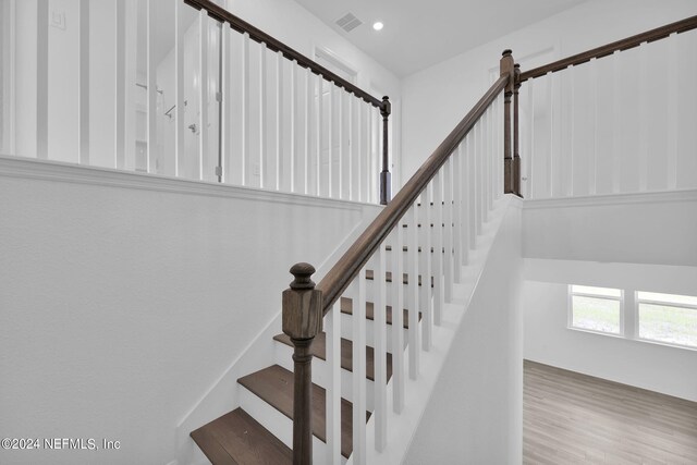 staircase featuring wood-type flooring