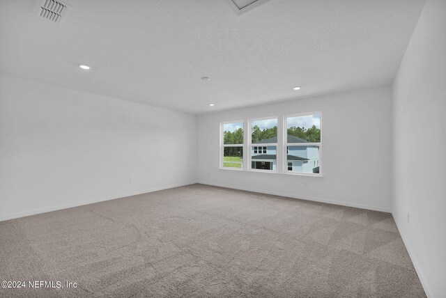 empty room featuring light colored carpet