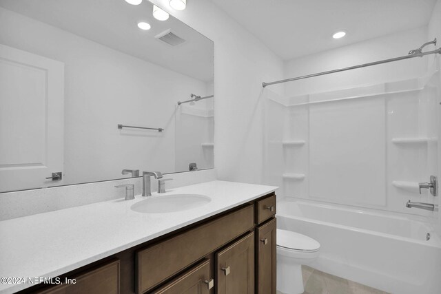 full bathroom with tile patterned flooring, vanity, toilet, and  shower combination