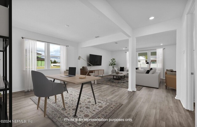 home office with light hardwood / wood-style floors