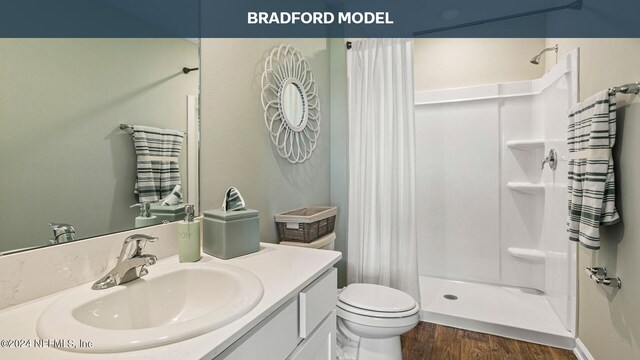 bathroom with walk in shower, vanity, toilet, and hardwood / wood-style flooring