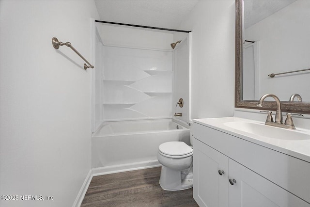 full bathroom with toilet, wood-type flooring, a textured ceiling, shower / washtub combination, and vanity