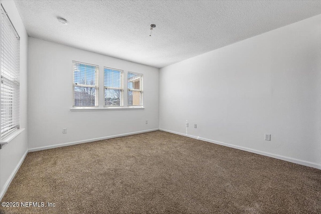 carpeted spare room with a textured ceiling