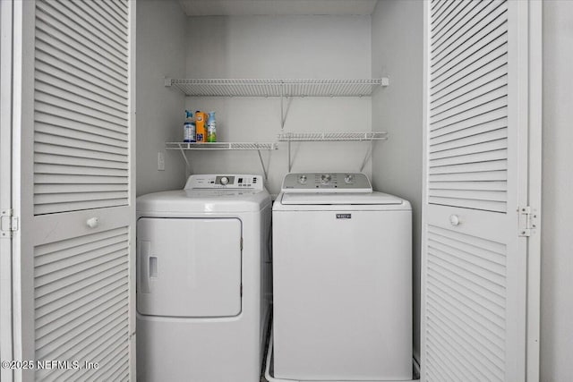 clothes washing area with washing machine and clothes dryer