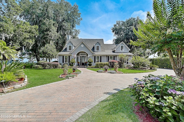 new england style home featuring a front yard