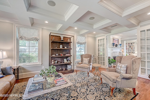 sitting room with hardwood / wood-style floors, a wealth of natural light, and coffered ceiling