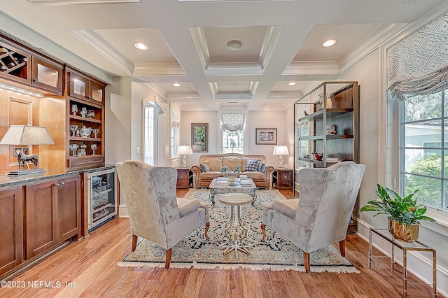 sitting room with plenty of natural light, light wood-type flooring, and coffered ceiling