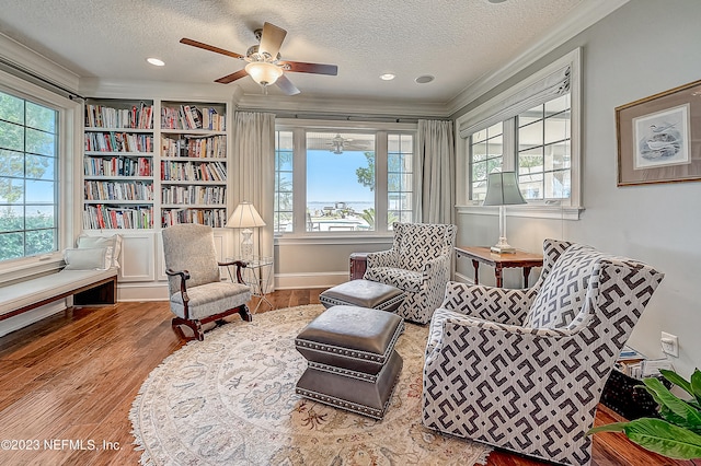 sitting room featuring a textured ceiling, hardwood / wood-style flooring, and plenty of natural light