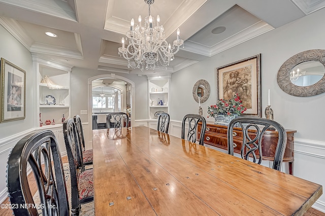 dining area with ornamental molding, a chandelier, built in shelves, and coffered ceiling