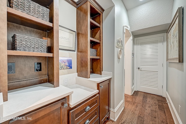 interior space featuring vanity and hardwood / wood-style flooring