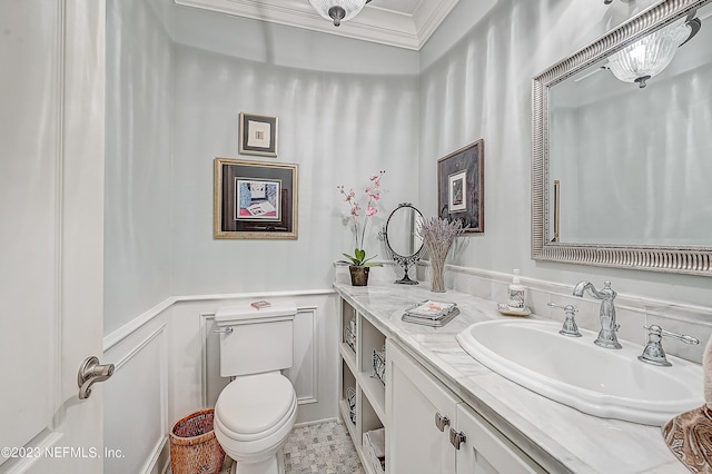 bathroom featuring tile flooring, ornamental molding, toilet, and large vanity