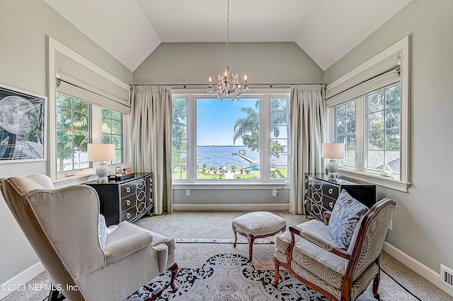 living area with a water view, plenty of natural light, vaulted ceiling, and carpet flooring