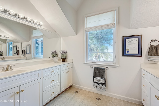 bathroom with lofted ceiling, large vanity, and tile flooring