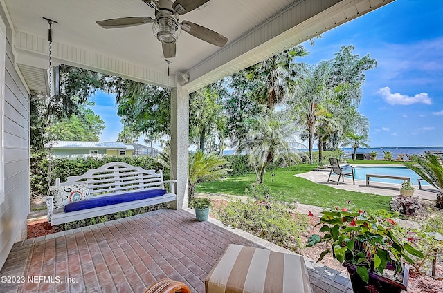 view of patio featuring ceiling fan and a water view